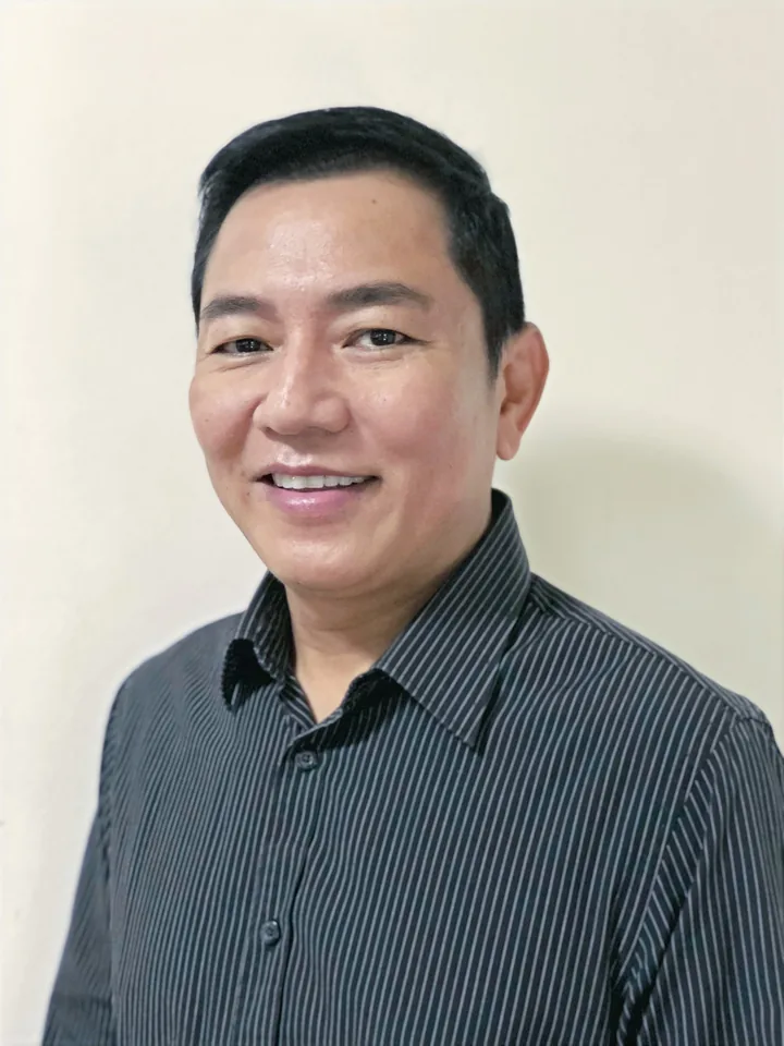 Jettana Sangchote smiling in a striped shirt